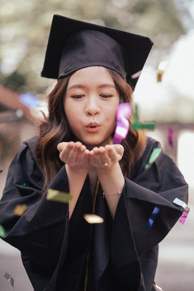 Female Graduate Blowing Confetti