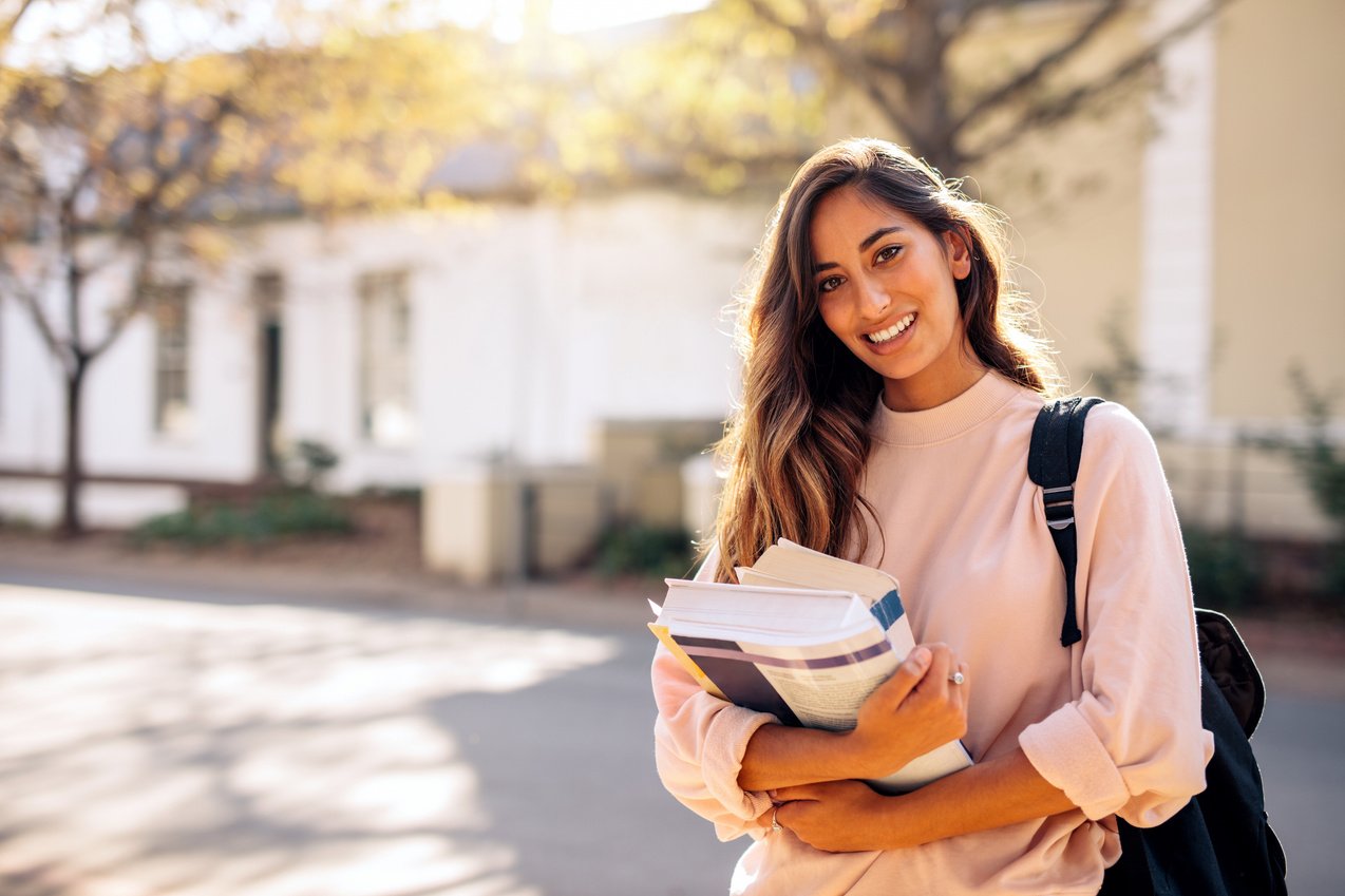 Female College Student with Books Outdoors